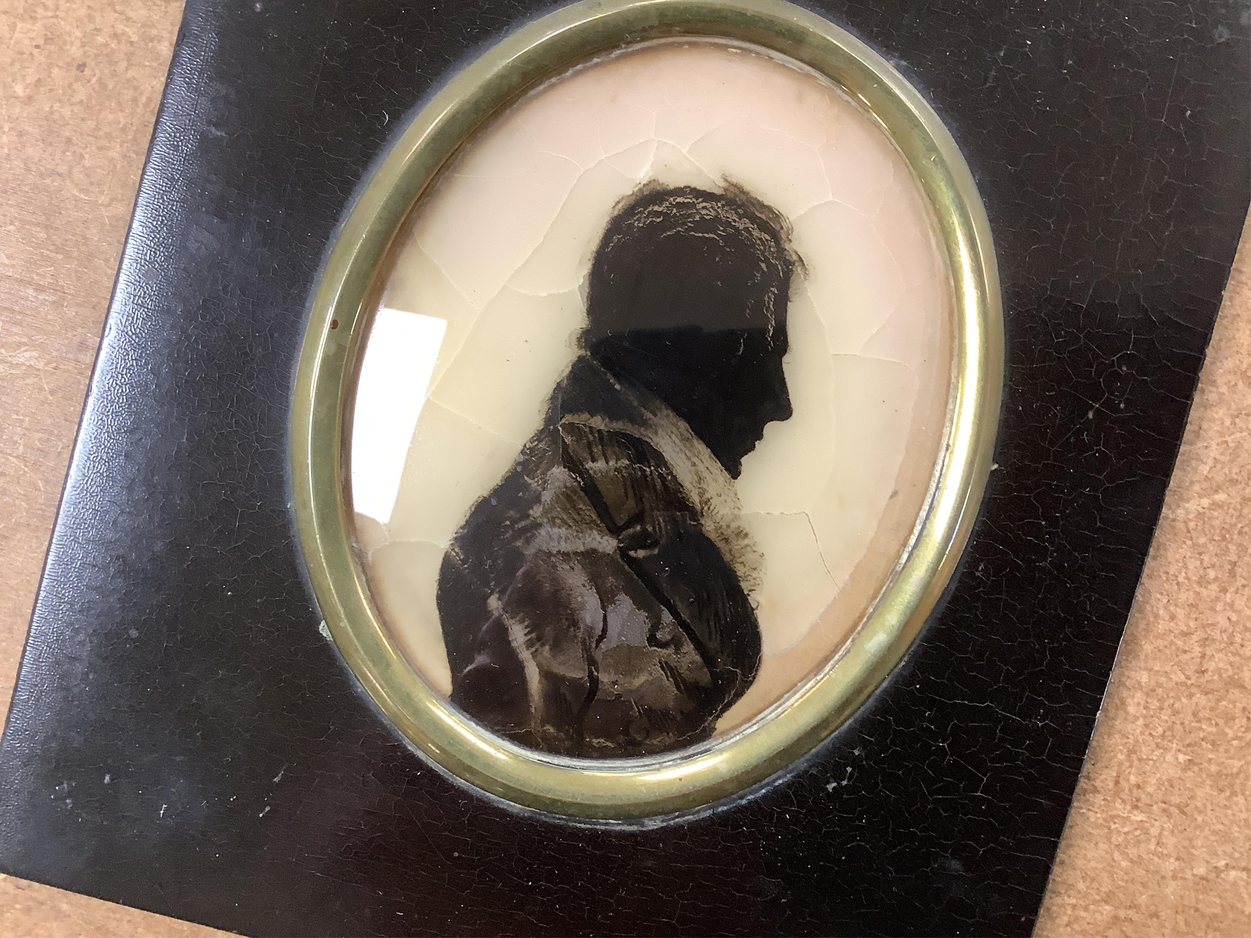 Two 19th century silhouette portraits to include one painted on glass by R. N. Barnes 1836 together with a portrait miniature of a Regency lady and an enamel example, largest 8 x 6.5cm (4)